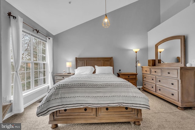 bedroom featuring baseboards, multiple windows, light colored carpet, and vaulted ceiling