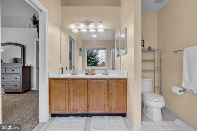 bathroom with a sink, visible vents, toilet, and double vanity