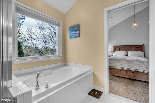 ensuite bathroom with ensuite bath, tile patterned floors, a bath, and lofted ceiling