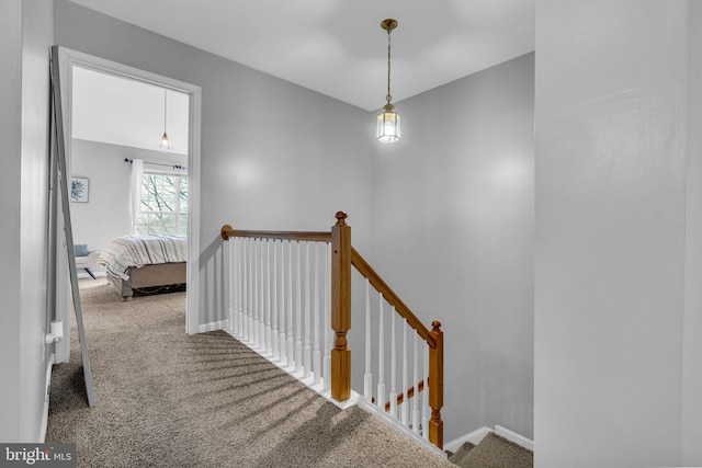 stairway with carpet flooring and baseboards