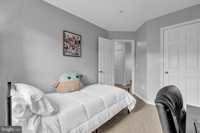 carpeted bedroom featuring baseboards