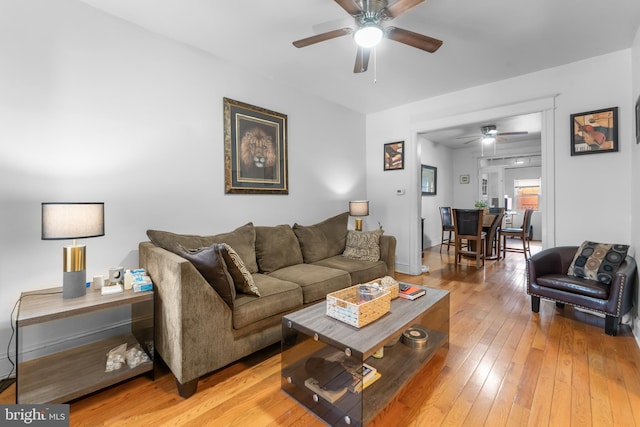 living room with light wood-style floors and ceiling fan