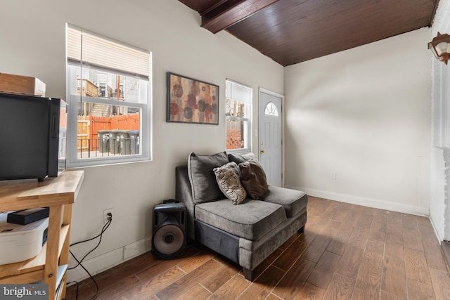 sitting room featuring beam ceiling, plenty of natural light, and wood finished floors