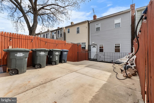 rear view of house with fence and a patio area