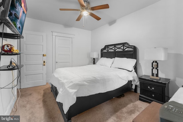 bedroom featuring a ceiling fan, a closet, and light carpet