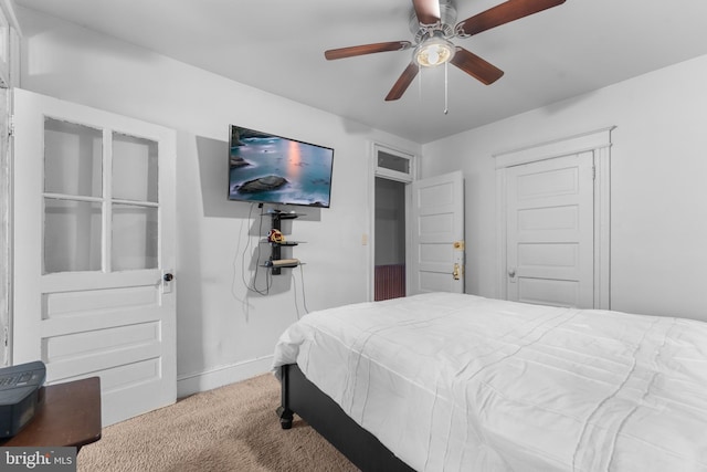 carpeted bedroom featuring a ceiling fan and baseboards