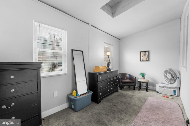 living area with baseboards, carpet floors, and an AC wall unit