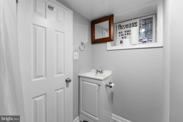 bathroom with baseboards and vanity