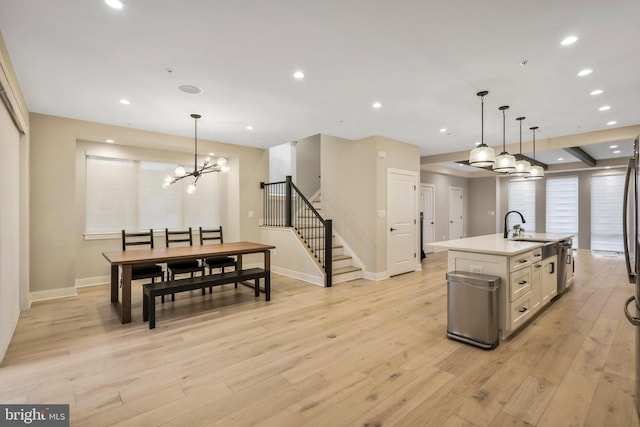 kitchen with a sink, light wood-type flooring, and recessed lighting