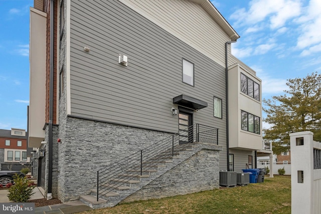 view of home's exterior featuring a yard and central AC