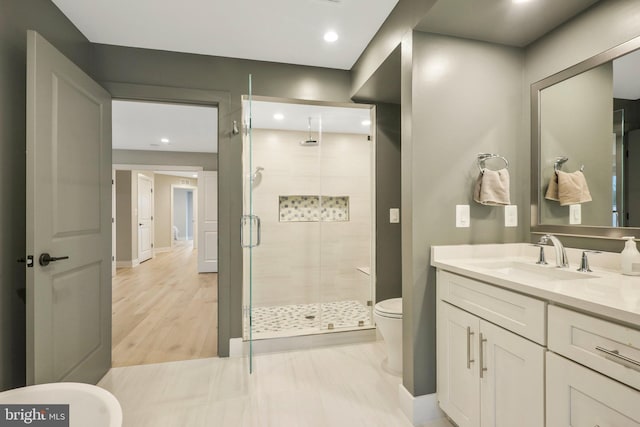 bathroom featuring vanity, baseboards, recessed lighting, a stall shower, and toilet