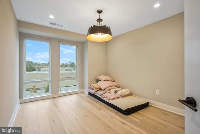 unfurnished room with recessed lighting, visible vents, baseboards, and wood finished floors