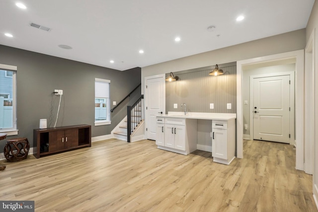 living area featuring stairway, recessed lighting, visible vents, and light wood-type flooring