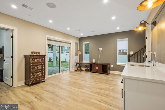 interior space with visible vents, light countertops, recessed lighting, light wood-style flooring, and a sink