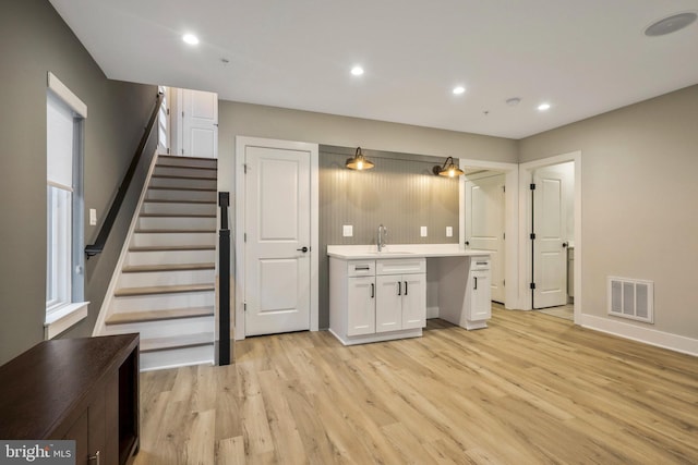 kitchen with white cabinetry, light wood-style flooring, recessed lighting, and visible vents