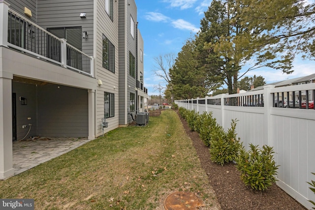 view of yard featuring a patio area, central AC, and fence