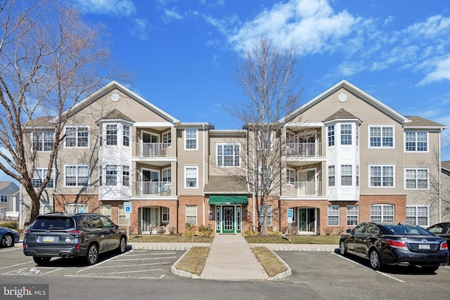 view of building exterior with uncovered parking