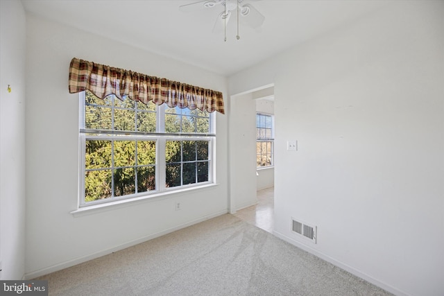 unfurnished room with visible vents, baseboards, a ceiling fan, and carpet floors