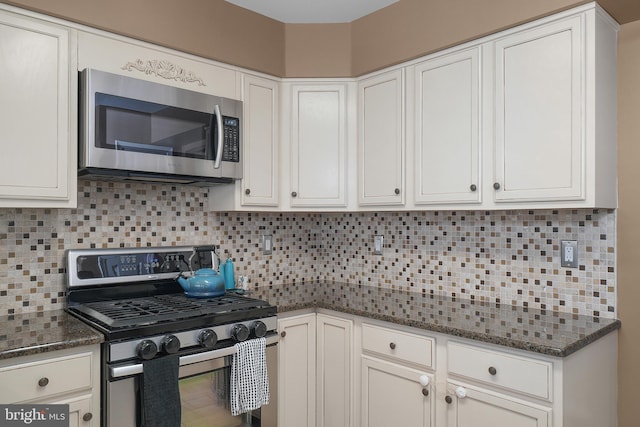 kitchen featuring white cabinetry, backsplash, and appliances with stainless steel finishes