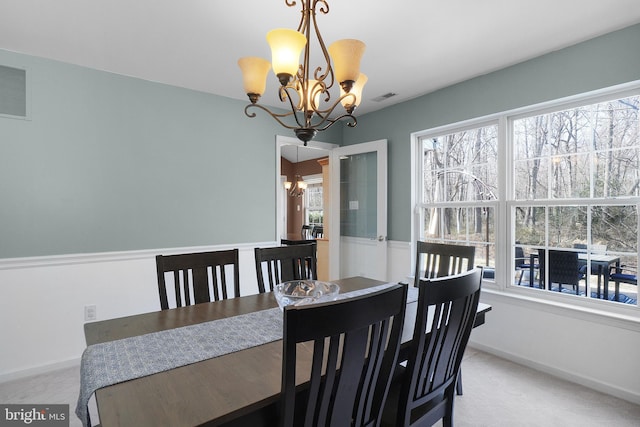 dining room with an inviting chandelier, visible vents, and a wealth of natural light