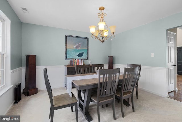 dining space featuring visible vents and a chandelier