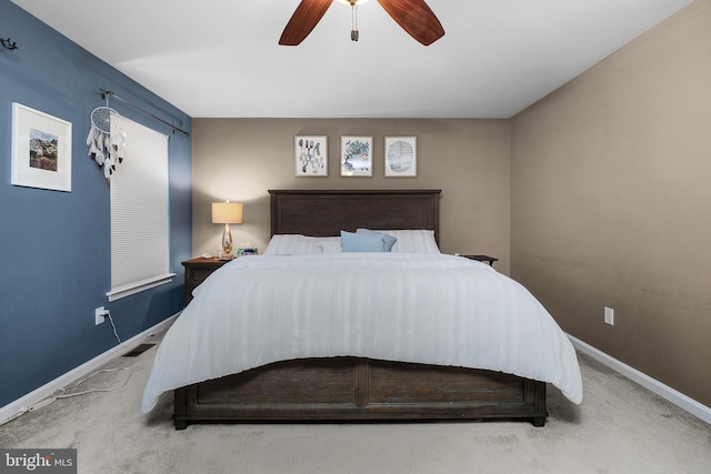 carpeted bedroom featuring visible vents, a ceiling fan, and baseboards