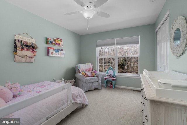 bedroom with a closet, a ceiling fan, baseboards, and carpet floors