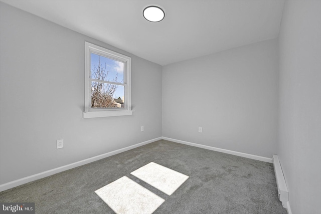 carpeted spare room featuring baseboards and baseboard heating