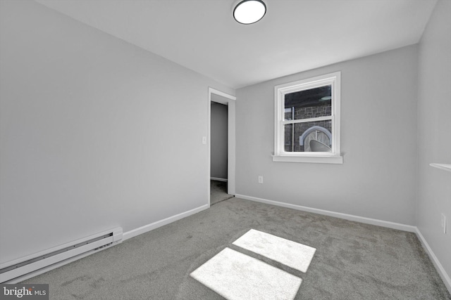 carpeted spare room featuring a baseboard radiator and baseboards