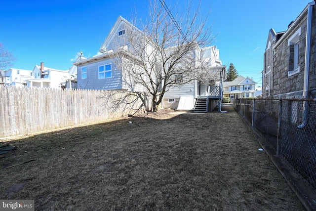 view of yard featuring a fenced backyard and a residential view