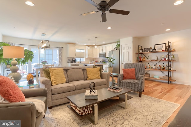 living area with recessed lighting, ceiling fan, and light wood-style floors