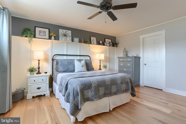 bedroom with ceiling fan, light wood-type flooring, and baseboards