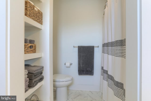 bathroom with a shower with curtain, toilet, baseboards, and marble finish floor