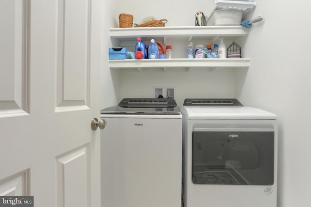 laundry area with washing machine and clothes dryer and laundry area