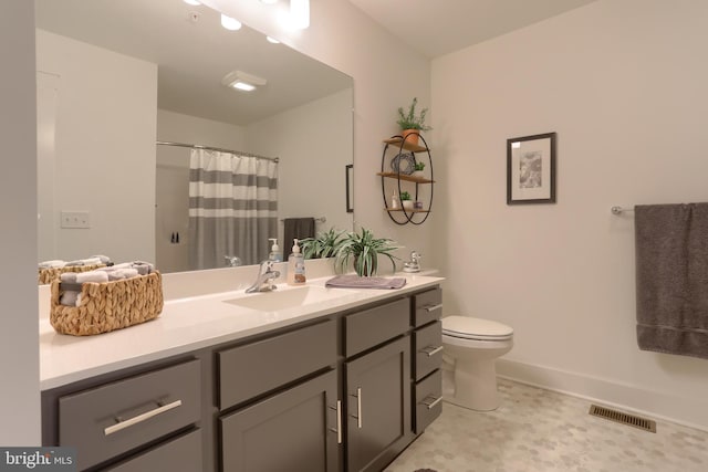 bathroom featuring visible vents, toilet, a shower with curtain, baseboards, and vanity