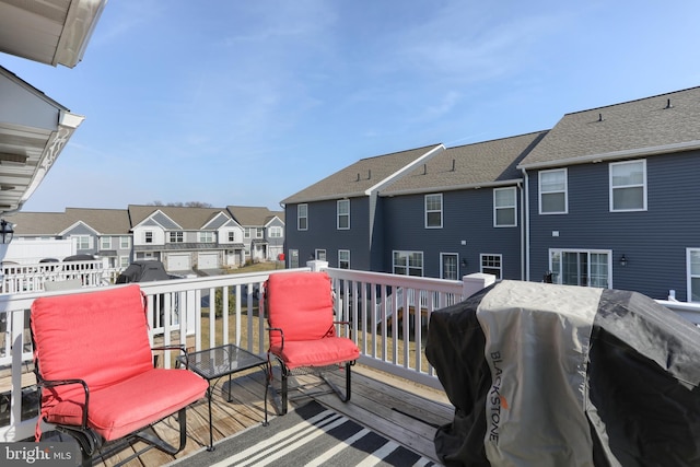 deck with a residential view and a grill