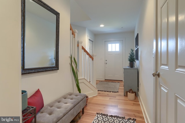 foyer featuring stairs, recessed lighting, wood finished floors, and baseboards