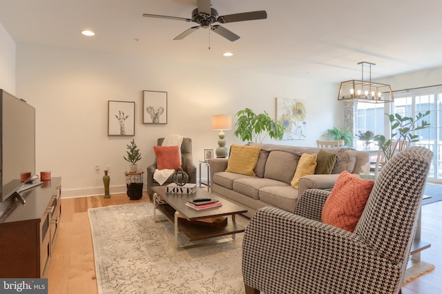 living area with recessed lighting, baseboards, light wood-style floors, and ceiling fan