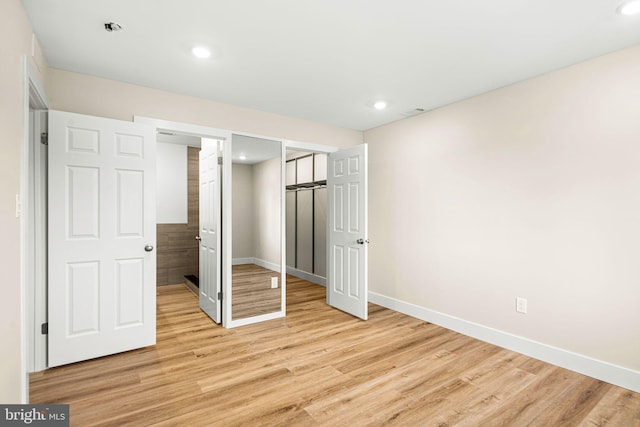 unfurnished bedroom with visible vents, baseboards, recessed lighting, light wood-style floors, and a closet