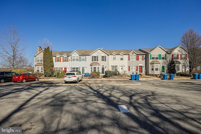 view of front of home featuring a residential view and a chimney