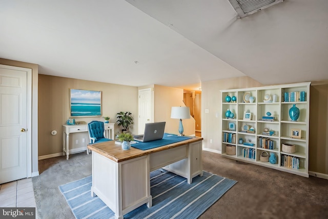 carpeted office featuring baseboards