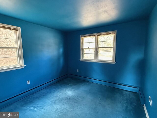1002 N New St, West Chester, PA 19380 - empty room featuring a baseboard heating unit, baseboards, and concrete flooring