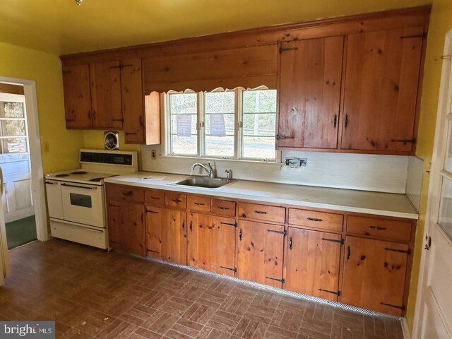 1002 N New St, West Chester, PA 19380 - kitchen featuring white electric range, brown cabinetry, light countertops, and a sink