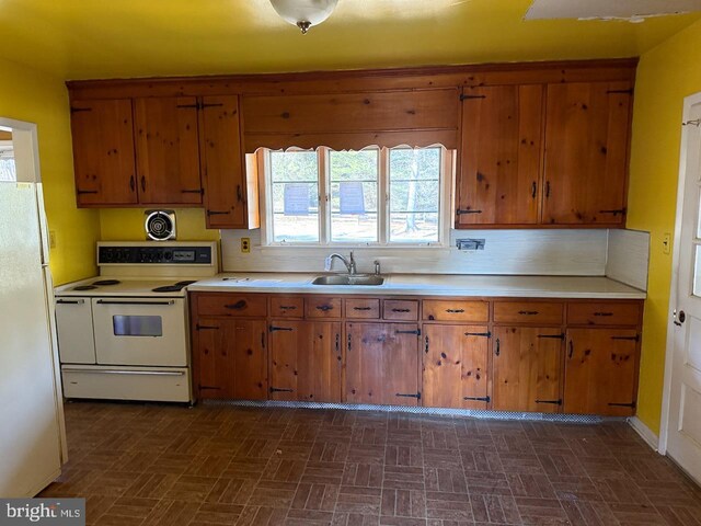 1002 N New St, West Chester, PA 19380 - kitchen with a sink, white appliances, brown cabinetry, and light countertops