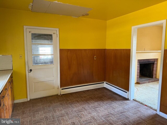 1002 N New St, West Chester, PA 19380 - interior space featuring a brick fireplace, a wainscoted wall, and brick patterned floor