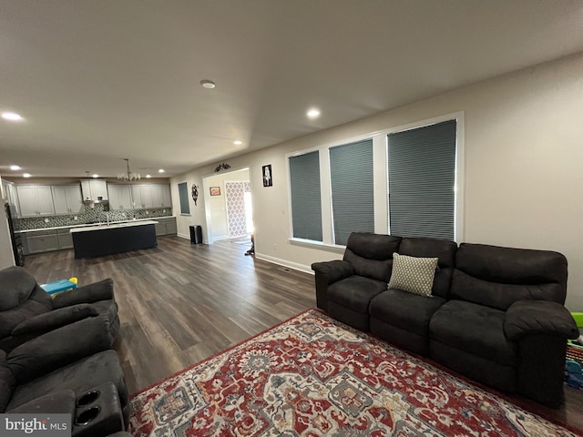 living area with dark wood finished floors, recessed lighting, and baseboards