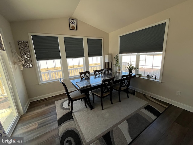 dining area featuring vaulted ceiling, wood finished floors, visible vents, and baseboards