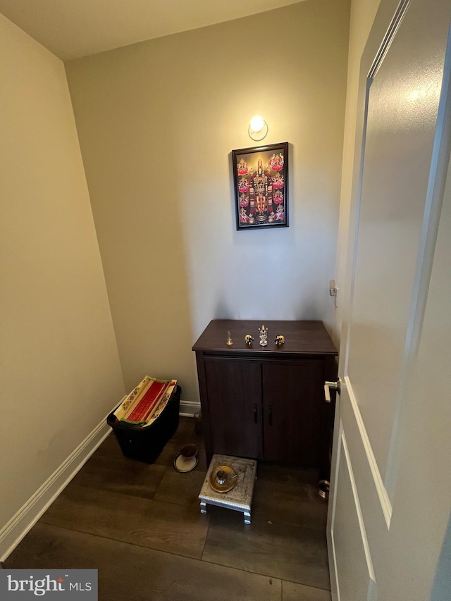 bathroom with wood finished floors and baseboards