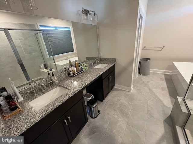 bathroom featuring a freestanding bath, a stall shower, and a sink