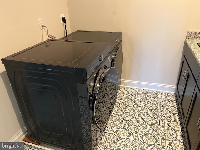 laundry room featuring baseboards, independent washer and dryer, laundry area, and tile patterned flooring